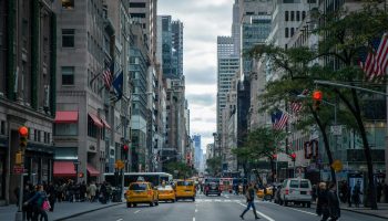 Vibrant street view of New York City with pedestrians, yellow cabs, and skyscrapers.